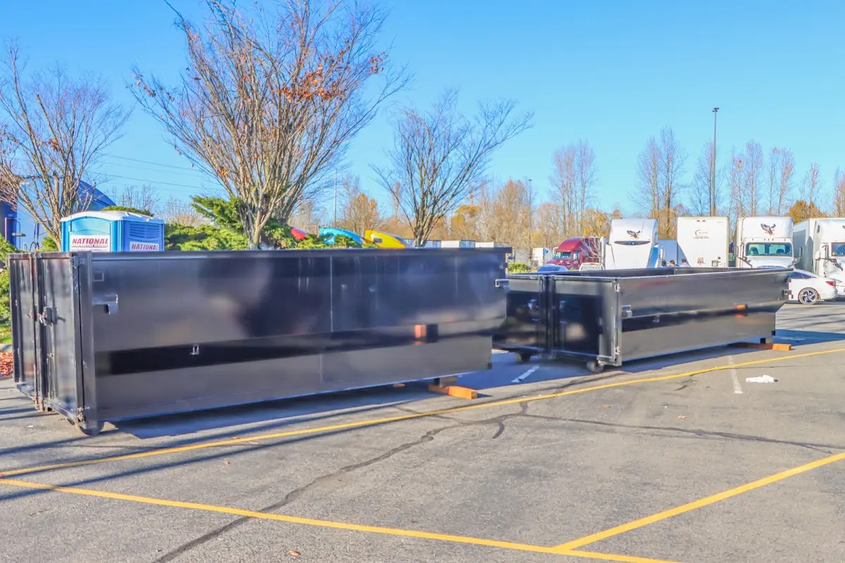 Professional dumpster rental service with roll-off container on residential driveway in Temple Hills